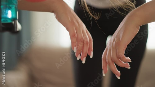Hands of woman resting on treadmill in gym photo