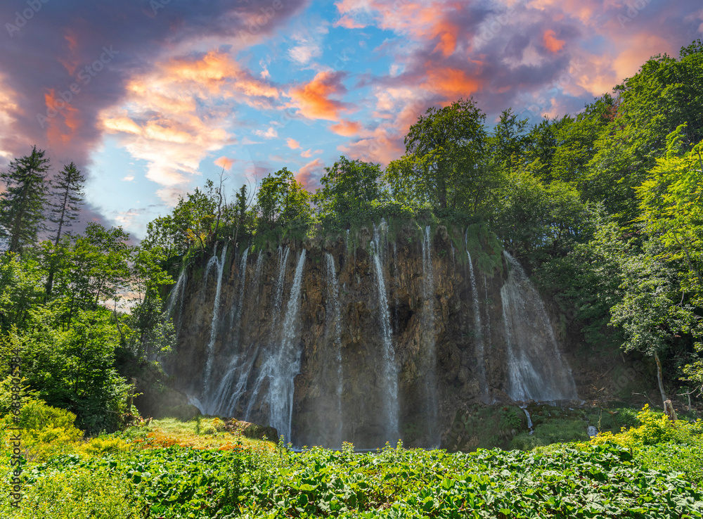 Picturesque waterfall. Waterfall among rocks and forest. Plitvice Lakes, Croatia.