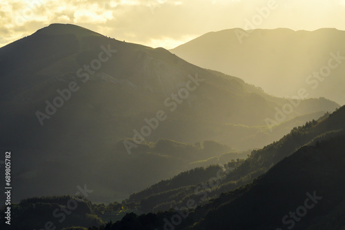 Silhouette of Mount Eretza with Ganekogorta in the background at sunrise photo