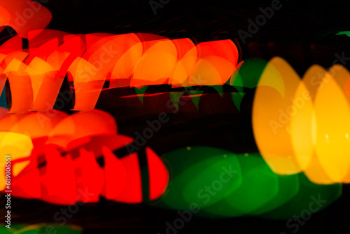 Multiple exposure vintage Christmas red, green, blue, orange and yellow lights on a black background