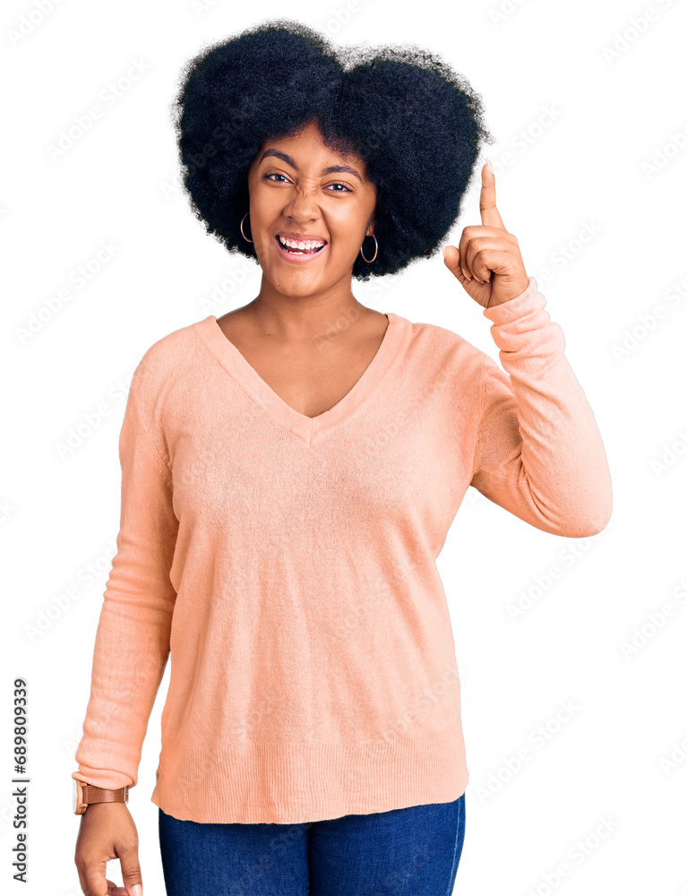 Young african american girl wearing casual clothes pointing finger up with successful idea. exited and happy. number one. Young african american girl wearing casual clothes pointing finger up with successful idea. exited and happy. number one.
