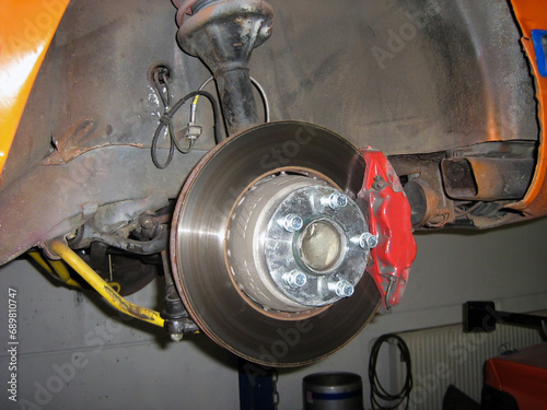 Repair of brake pads on a car. Wheel removed for brake replacement or repair