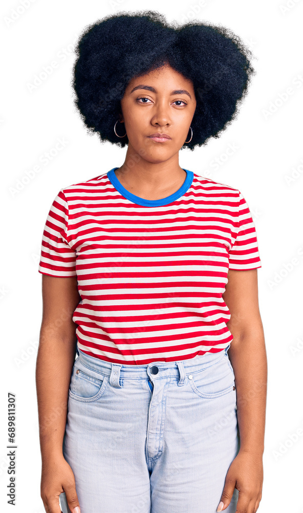 Young african american girl wearing casual clothes with serious expression on face. simple and natural looking at the camera. Young african american girl wearing casual clothes with serious expression on face. simple and natural looking at the camera.