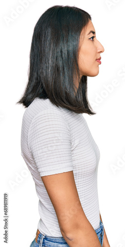 Beautiful asian young woman wearing casual white t shirt looking to side, relax profile pose with natural face with confident smile.