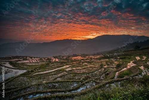 Aerial view of Honghe Hani Rice Terraces on the hills at sunset in Yunnan province, China. photo