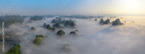 Aerial view of Guilin mountain landscape at sunrise with low clouds over the valley and fog, Guangxi, China.