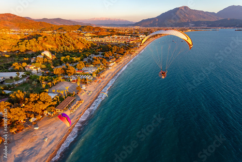 Aerial view of paramotors flying in formation at Calis Beach of Fethiye, Mugla, Turkey. photo