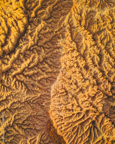 Aerial view of abstract rocks in the Bardenas Reales Desert at sunrise, Navarra, Spain.