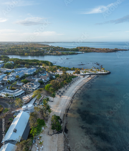 Aerial view of a luxury resort along the coastline and Riviere du Rampart river and bay in background, Opaline, Azuri Village, Rivière du Rempart, Mauritius. photo