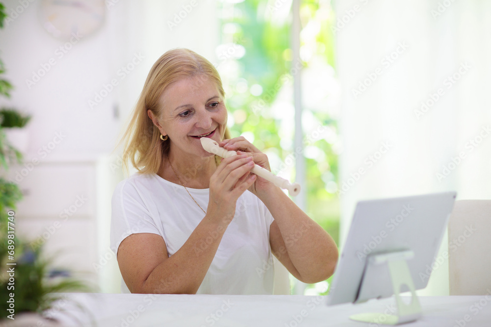 Teacher playing flute. Remote learning. Teacher playing flute. Remote learning.