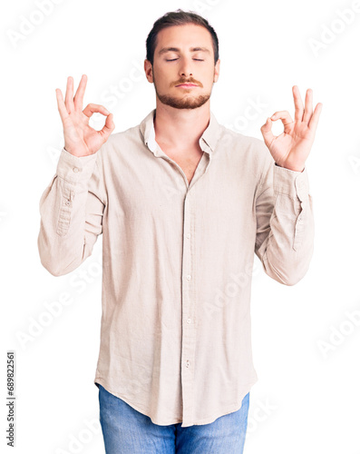 Young handsome caucasian man wearing casual clothes relax and smiling with eyes closed doing meditation gesture with fingers. yoga concept.