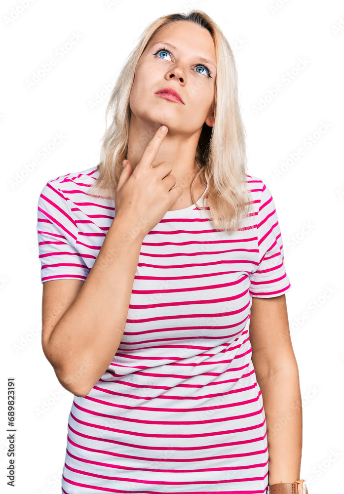 Young caucasian woman wearing casual clothes thinking concentrated about doubt with finger on chin and looking up wondering Young caucasian woman wearing casual clothes thinking concentrated about doubt with finger on chin and looking up wondering