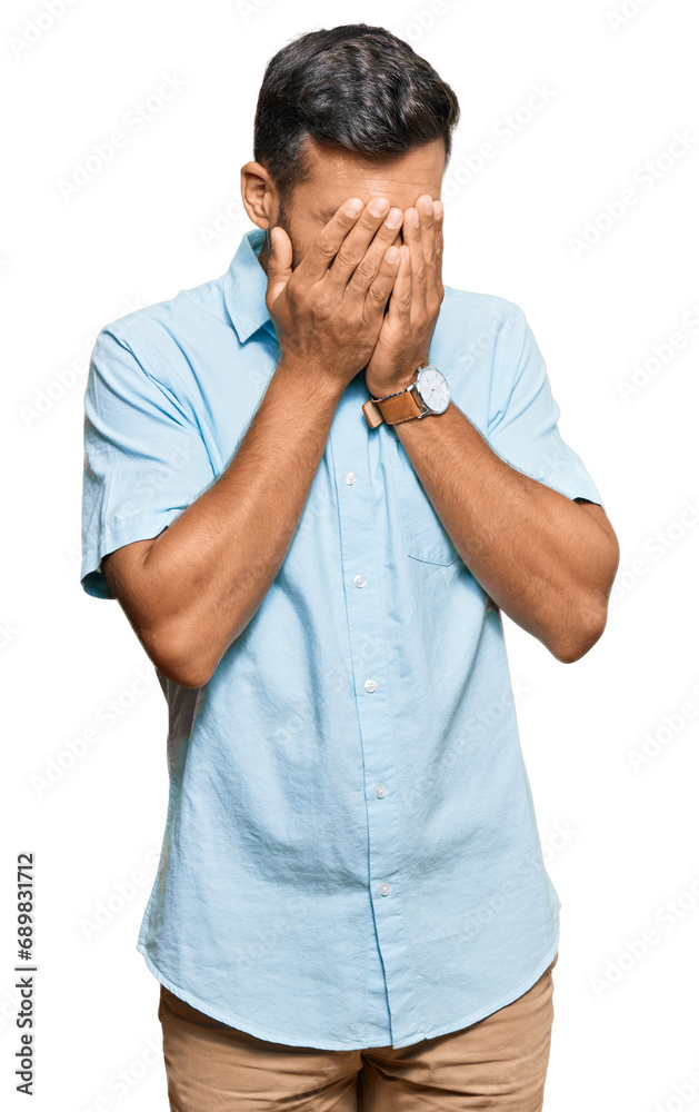 Fototapeta premium Handsome hispanic man wearing casual clothes with sad expression covering face with hands while crying. depression concept.