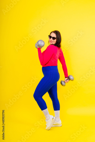 Young smiling happy chubby overweight plus size big fat fit woman warm up training hold dumbbells © Ivan Zelenin
