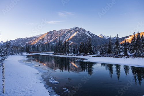 Wintry landscape of mountains and river in Banff at sunset