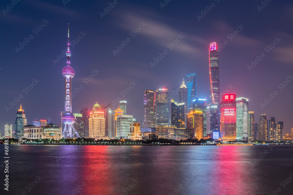 View of Shanghai skyline at night, view of the financial district along the Huangpu River, China. View of Shanghai skyline at night, view of the financial district along the Huangpu River, China.