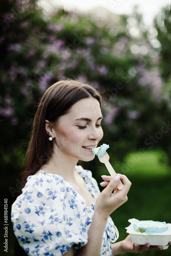 Young woman in floral dress on a picnic in the park
