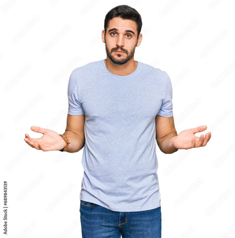 Young hispanic man wearing casual clothes clueless and confused with open arms, no idea concept. Young hispanic man wearing casual clothes clueless and confused with open arms, no idea concept.