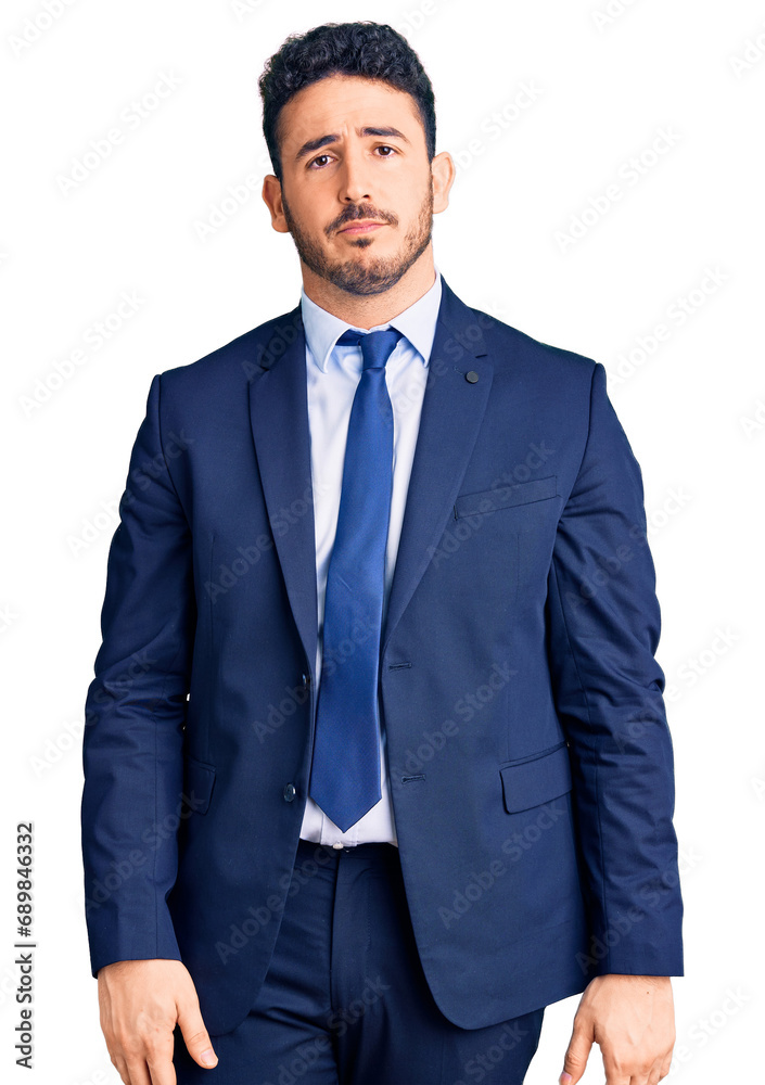 Young hispanic man wearing business clothes with serious expression on face. simple and natural looking at the camera. Young hispanic man wearing business clothes with serious expression on face. simple and natural looking at the camera.