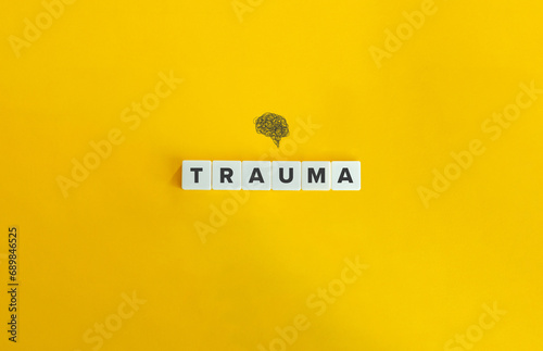 Trauma and Brain. Block Letter Tiles on Yellow Background. Minimal Aesthetics. photo