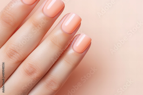 woman hand with perfect peach fuzz color manicure  close up  nail salon ad