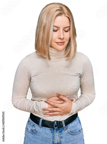 Young blonde woman wearing casual clothes with hand on stomach because indigestion, painful illness feeling unwell. ache concept.