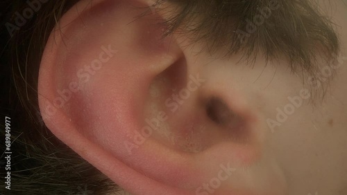 Male right ear. The part of the body responsible for hearing and perception of sounds. The problem of perception, deafness, human anatomy, the concept of hearing. Macro shot. photo