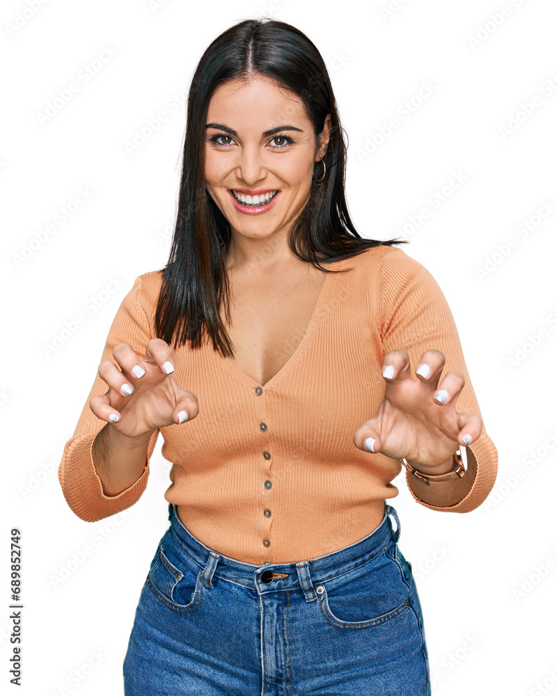Young hispanic woman wearing casual clothes smiling funny doing claw gesture as cat, aggressive and sexy expression Young hispanic woman wearing casual clothes smiling funny doing claw gesture as cat, aggressive and sexy expression