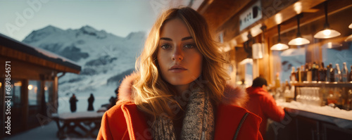 Pretty woman in amazing winter mountains. Apres ski venue photo