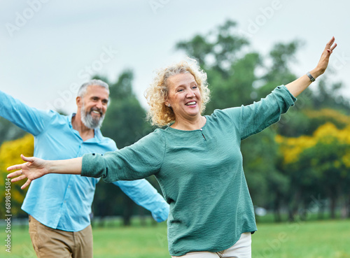 woman man couple happy together mature active balance walk balancing challenge step exercise recreation acrobat game bonding love outdoor walking leisure park fun exercise sport middle mid aged active photo