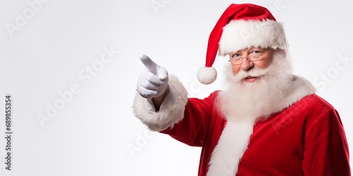 Smiling Santa Claus pointing on blank advertisement banner background with copy space