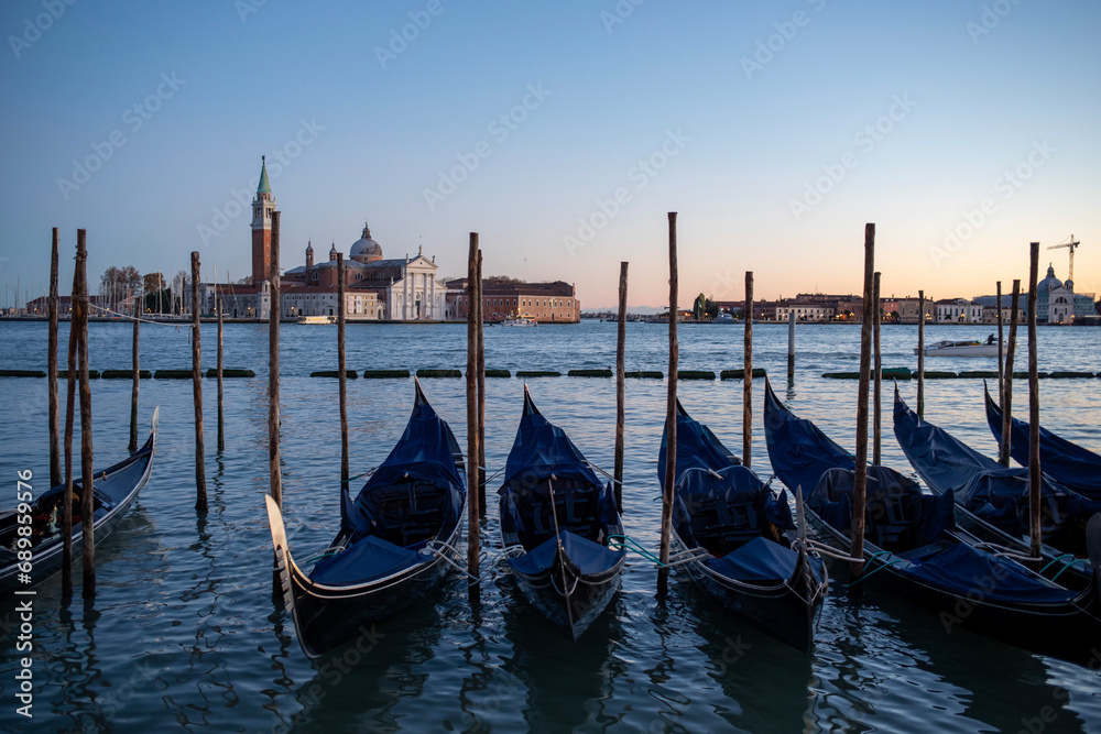 Gondolas along the Grand Canal in Venice, Italy at sunset. 