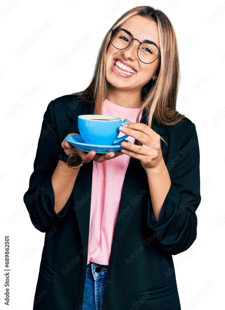 Hispanic young woman drinking a cup of coffee smiling with a happy and cool smile on face. showing teeth. Hispanic young woman drinking a cup of coffee smiling with a happy and cool smile on face. showing teeth.