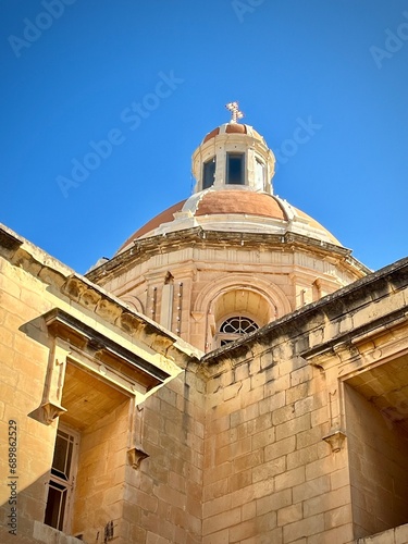 view of the dome of a catholic church in malta on a sunny summer day
 photo