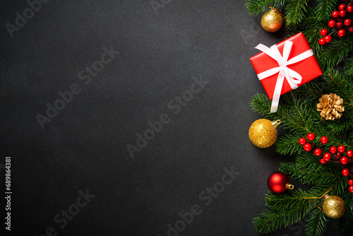 Christmas background with christmas tree, present box and holidays decorations. Flat lay image with copy space.