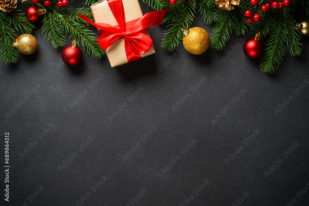 Black christmas flat lay background. Christmas tree with present box and holidays decorations at black.