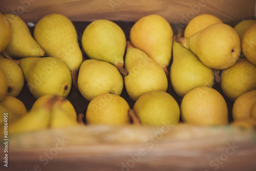 Closeup of delicious pears arranged in a crate. very tasty,sweet and juicy pears fruits, close up. Group of fresh fruits at a local market. 