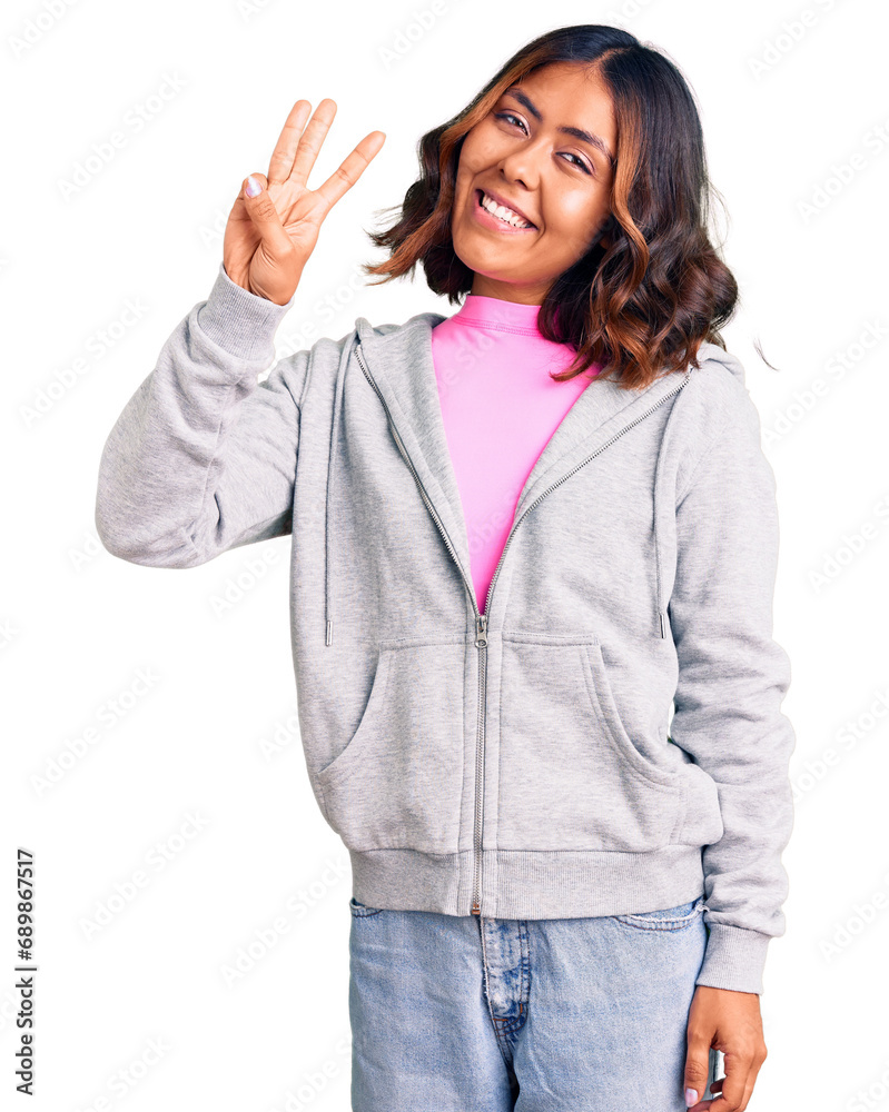 Young beautiful mixed race woman wearing casual sporty clothes showing and pointing up with fingers number three while smiling confident and happy. Young beautiful mixed race woman wearing casual sporty clothes showing and pointing up with fingers number three while smiling confident and happy.