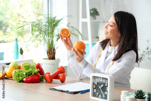 Female nutritionist holding...