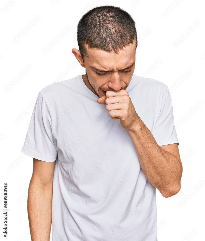Hispanic young man wearing casual white t shirt feeling unwell and coughing as symptom for cold or bronchitis. health care concept. Hispanic young man wearing casual white t shirt feeling unwell and coughing as symptom for cold or bronchitis. health care concept.