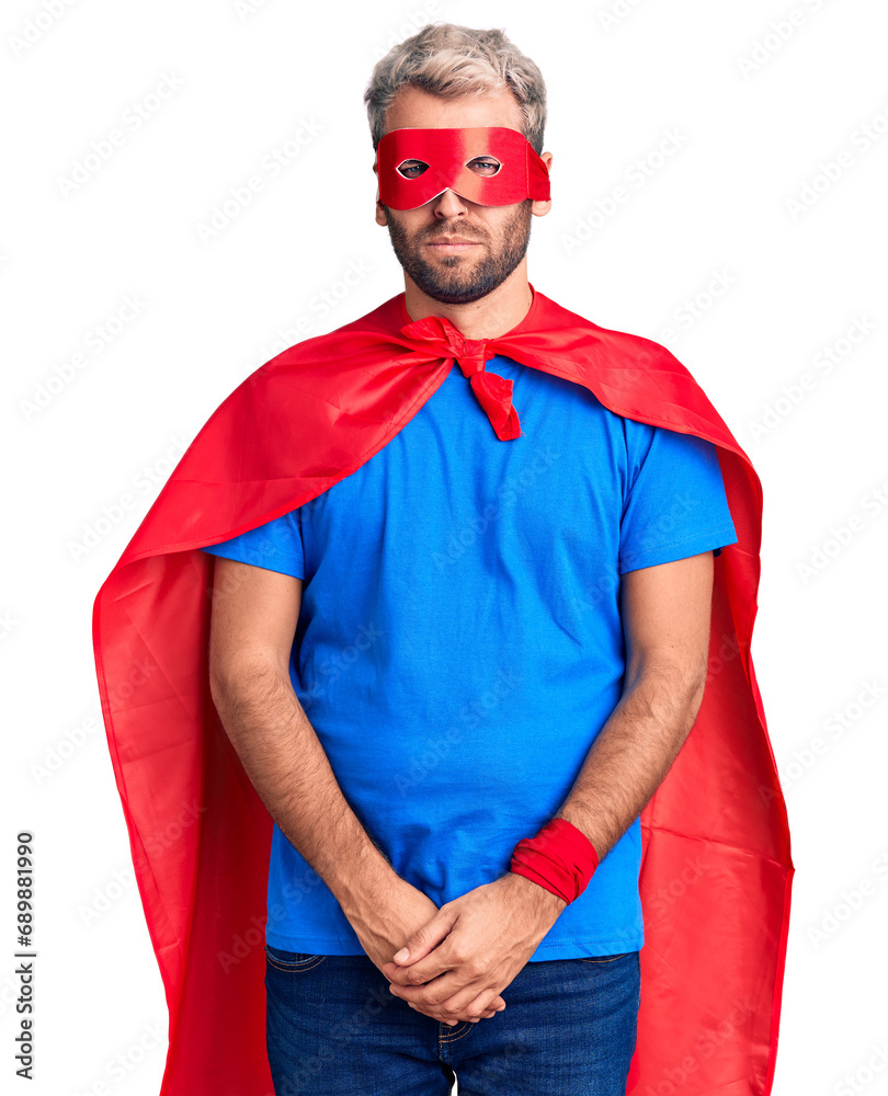 Young blond man wearing super hero custome skeptic and nervous, frowning upset because of problem. negative person. Young blond man wearing super hero custome skeptic and nervous, frowning upset because of problem. negative person.