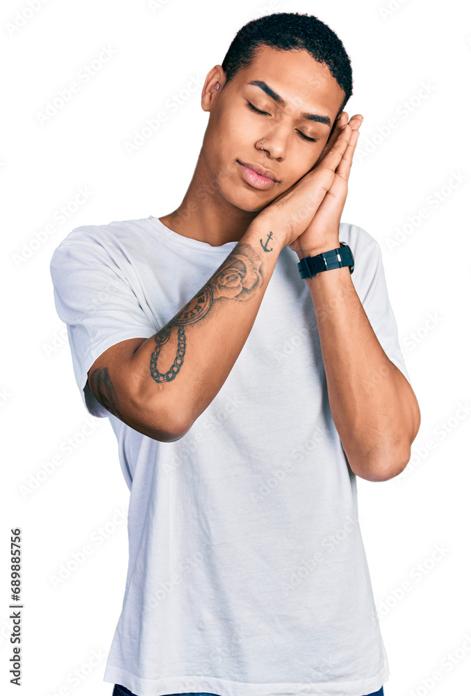 Young hispanic man wearing casual white t shirt sleeping tired dreaming and posing with hands together while smiling with closed eyes. Young hispanic man wearing casual white t shirt sleeping tired dreaming and posing with hands together while smiling with closed eyes.