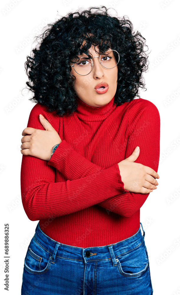 Young middle east girl wearing casual clothes and glasses shaking and freezing for winter cold with sad and shock expression on face Young middle east girl wearing casual clothes and glasses shaking and freezing for winter cold with sad and shock expression on face