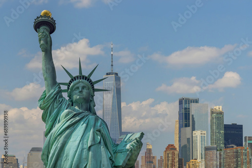 AStatue of Liberty with beautifully Manhattan at New York City background © ungvar