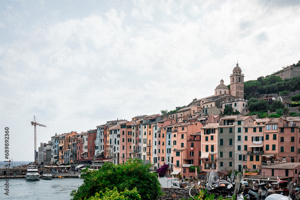 View of apartment buildings near shore with historical architecture between in Portovenere, Italy