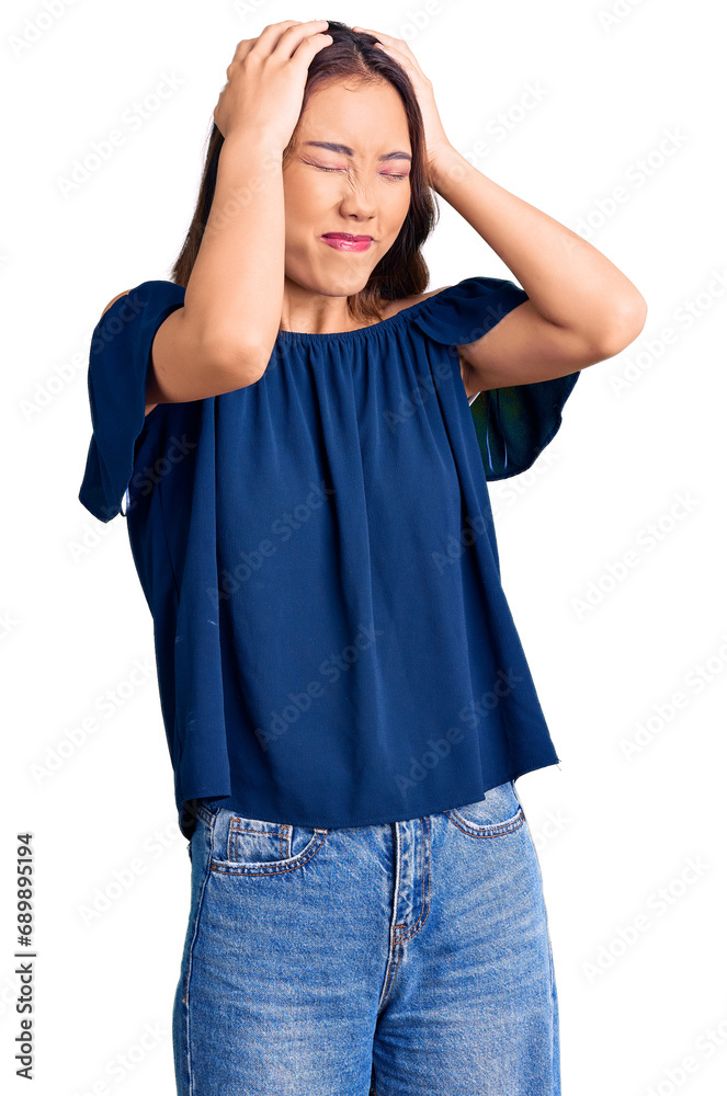 Young beautiful chinese girl wearing casual clothes suffering from headache desperate and stressed because pain and migraine. hands on head. Young beautiful chinese girl wearing casual clothes suffering from headache desperate and stressed because pain and migraine. hands on head.