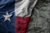 waving flag of texas state on the old khaki texture background. military concept.