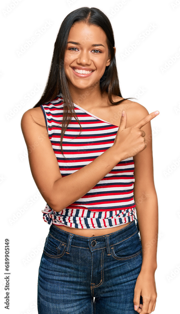 Beautiful hispanic woman wearing casual clothes cheerful with a smile of face pointing with hand and finger up to the side with happy and natural expression on face Beautiful hispanic woman wearing casual clothes cheerful with a smile of face pointing with hand and finger up to the side with happy and natural expression on face