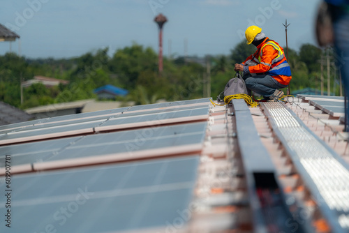 Worker Technicians are working to construct solar panels system on roof. Installing solar photovoltaic panel system. Alternative energy ecological concept. Renewable clean energy technology concept.