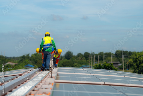 Wallpaper Mural Worker Technicians are working to construct solar panels system on roof. Installing solar photovoltaic panel system. Alternative energy ecological concept. Renewable clean energy technology concept. Torontodigital.ca